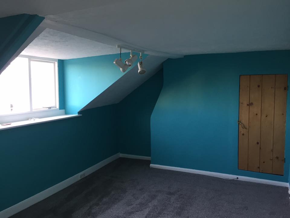 Loft bedroom painted in blue