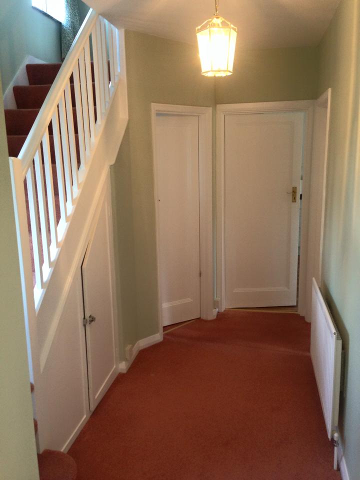 Hallway and staircase with freshly painted white spindles and woodwork