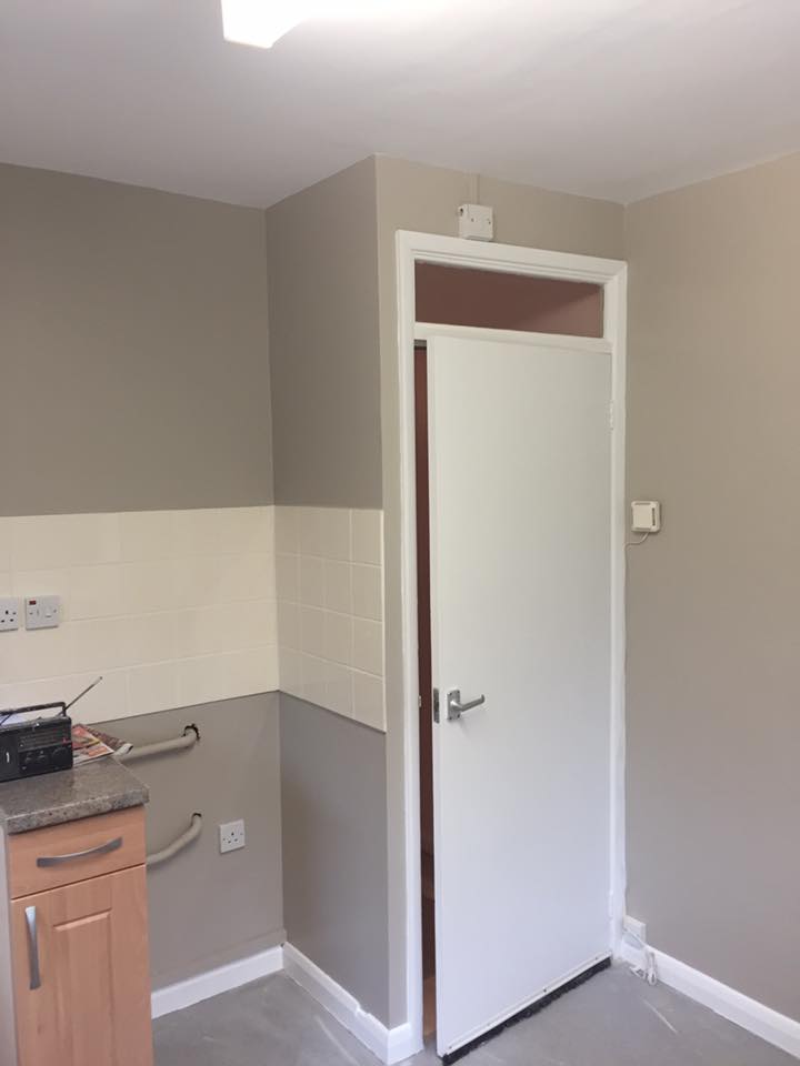 Grey kitchen with white tiling, freshly painted
