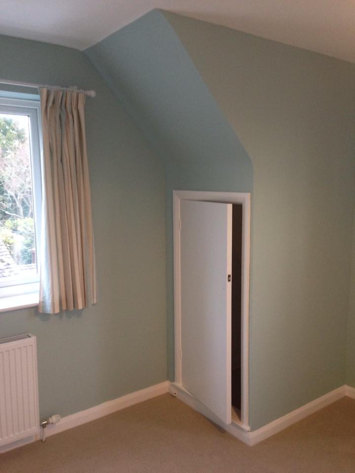 Bedroom painted in duck-egg blue with crisp white woodwork