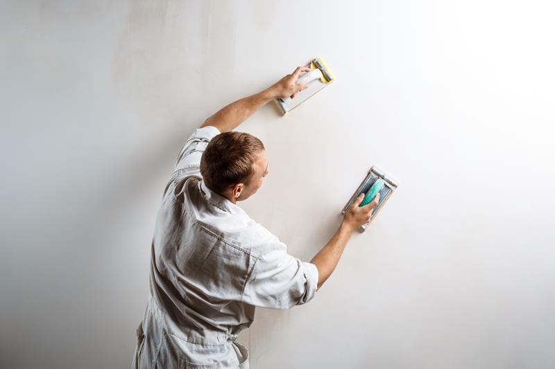 Walls being prepared and sanded before painting
